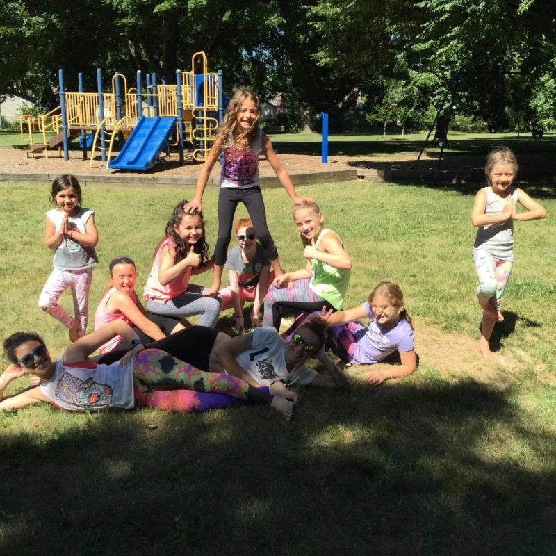 Group of children outside at a park smiling at the camera